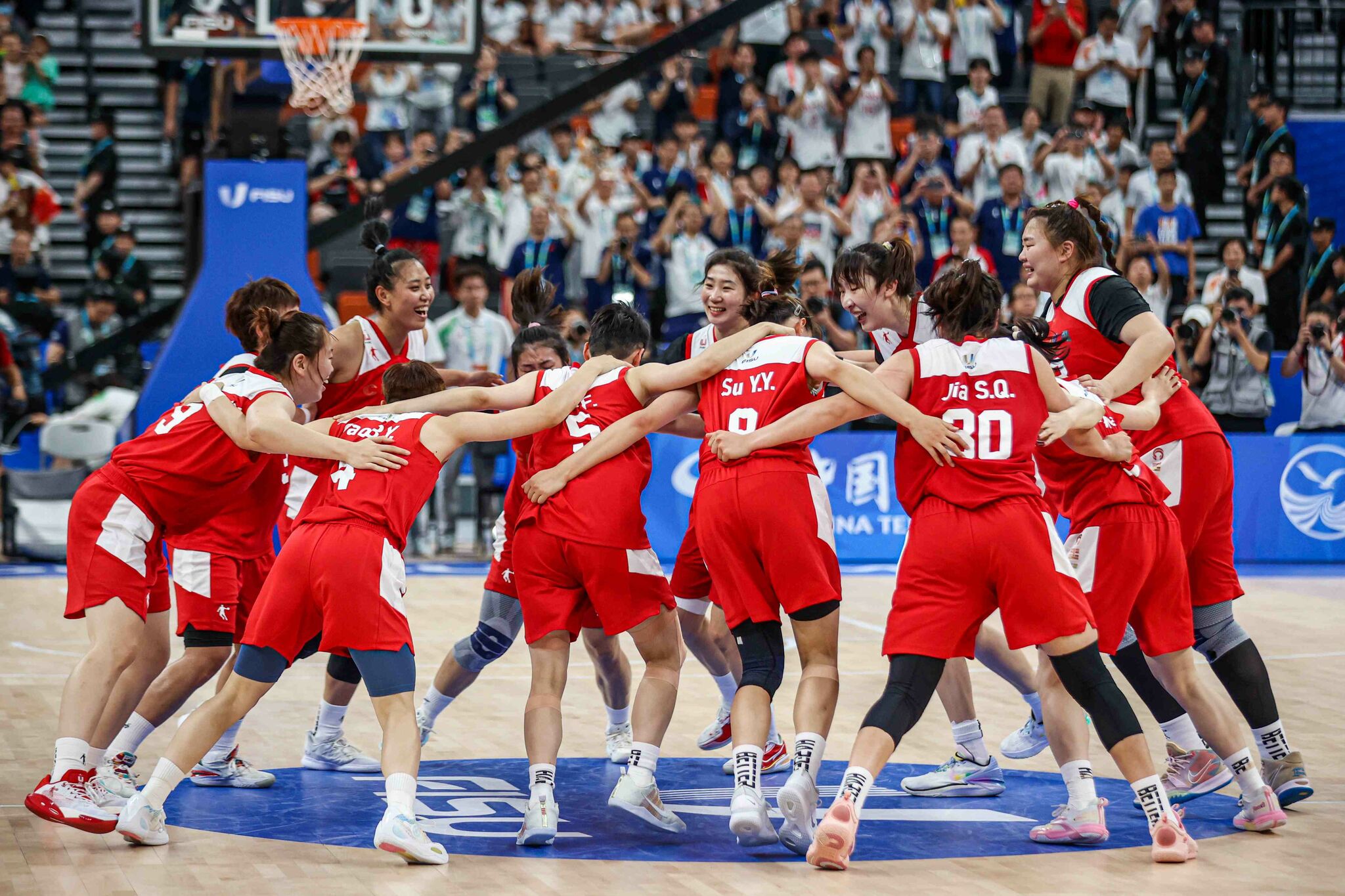 Members of Team China celebrate their victory